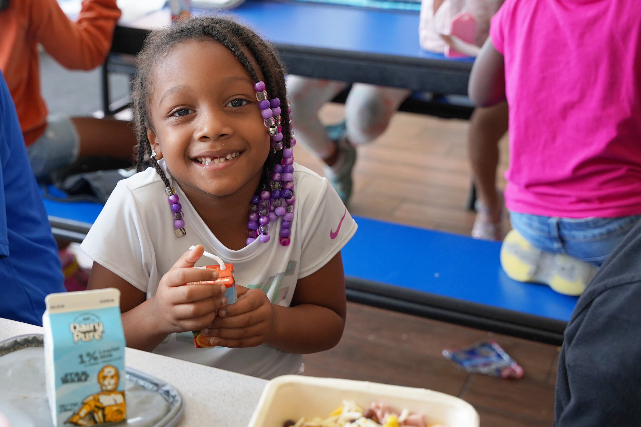 A student enjoys lunch at a free summer meal site for kids.
